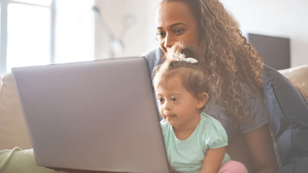 A mother and daughter using laptop at home 