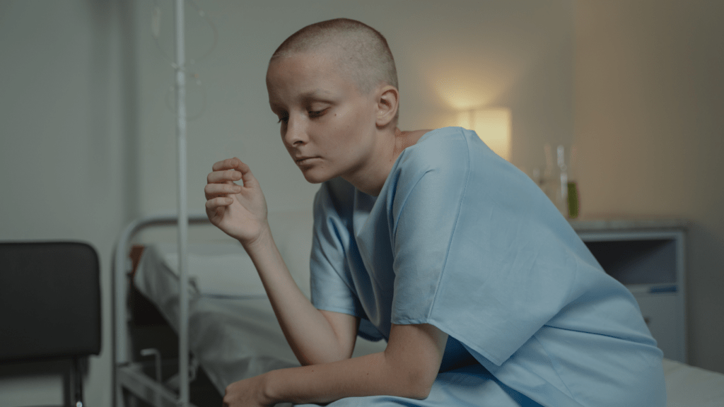 A person sitting on a bed in a hospital room