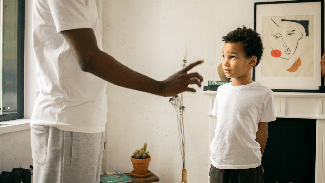 a person talking to a young person in a living room