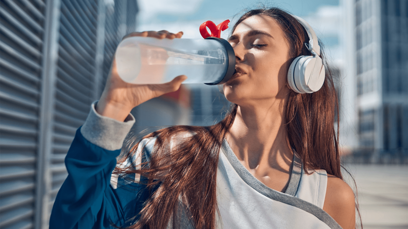 a person drinking from a water bottle