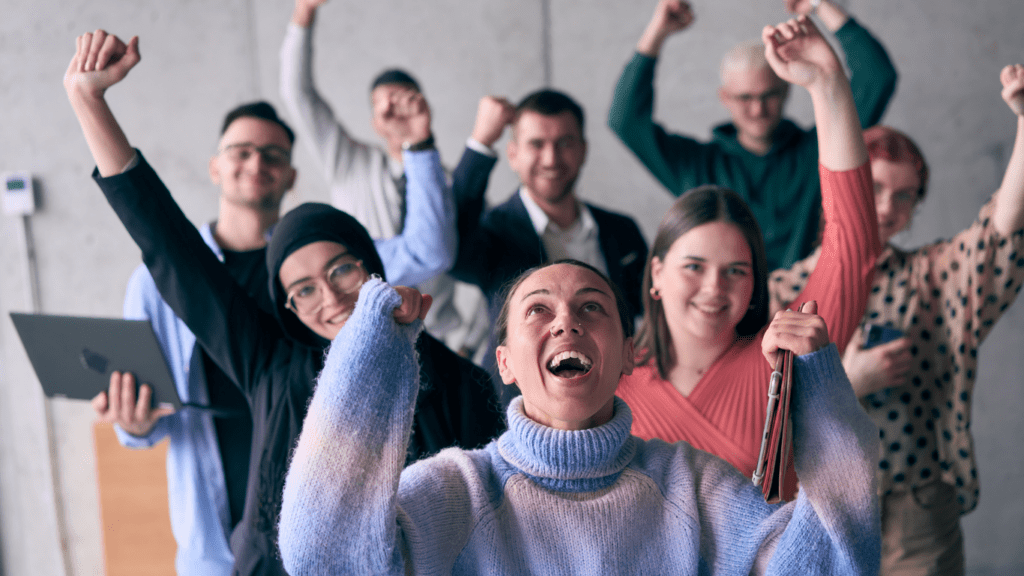 a group of people raising their arms in the air