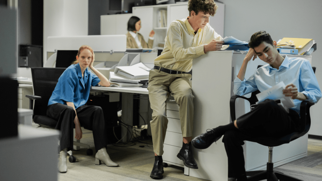 a group of people sitting at a desk in an office