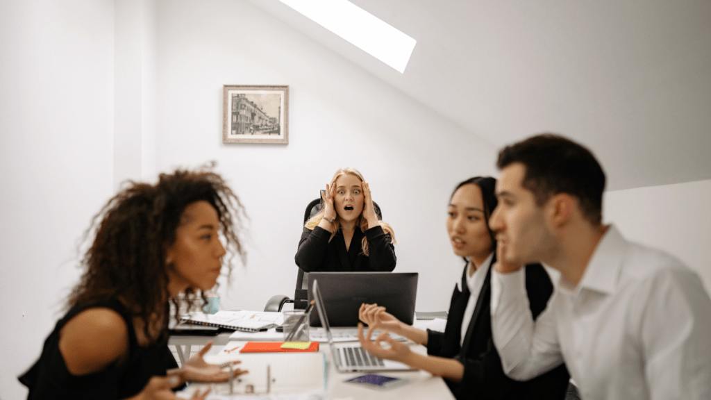 a group of people sitting at a table in an office