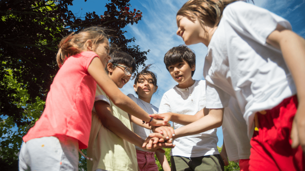 a group of children holding hands in a circle