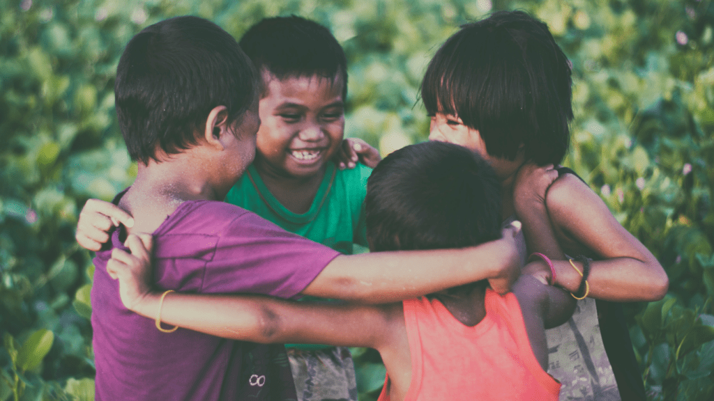 a group of children holding hands in a circle