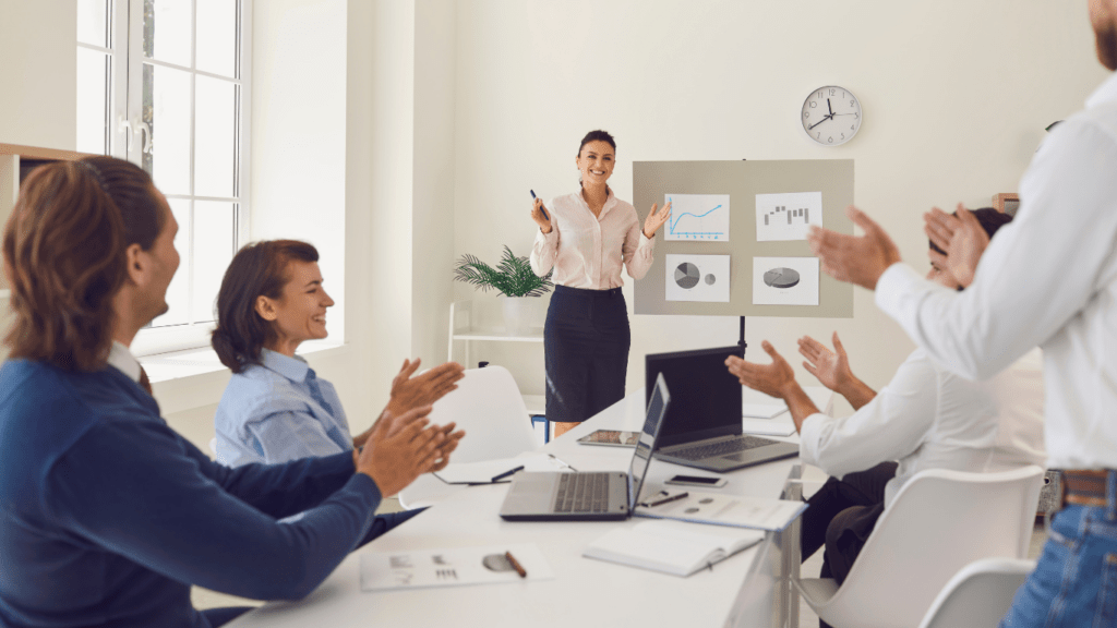 a group of people raising their hands in a meeting