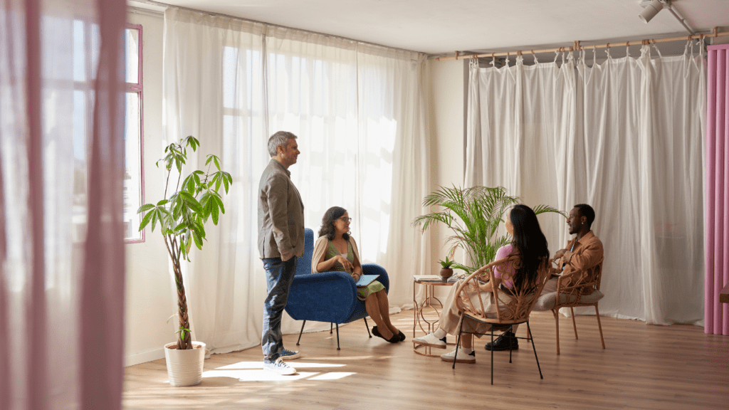 a group of people sitting around a table in an office