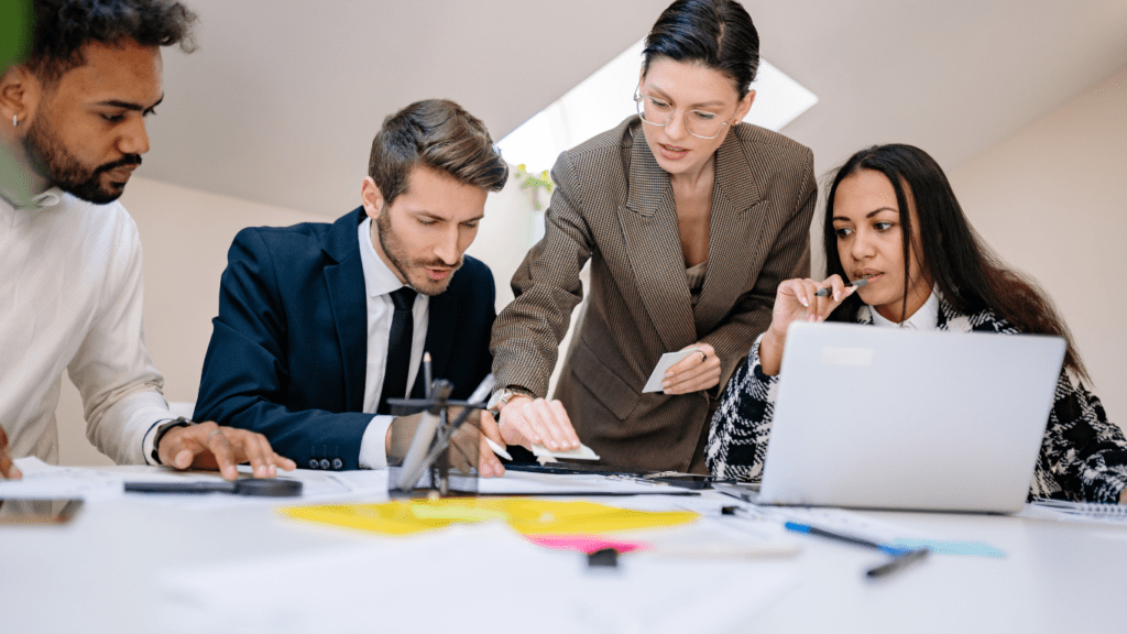 a group of people sitting at a table in an office