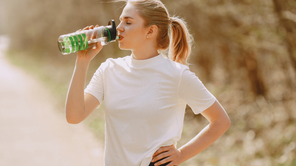 a person drinking from a water bottle