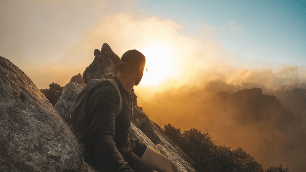 a person is climbing on the side of a mountain