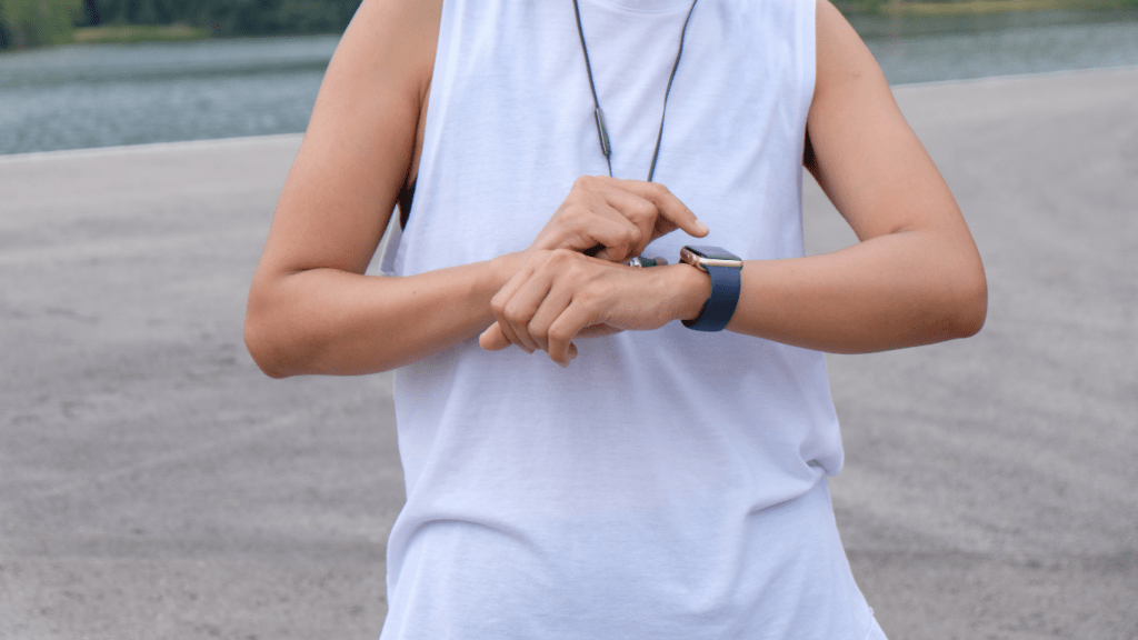 a person is looking at their watch while standing on the road