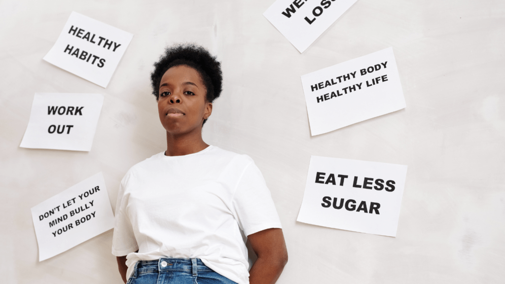 a person posing in front of a wall with a sign that says healthy habits