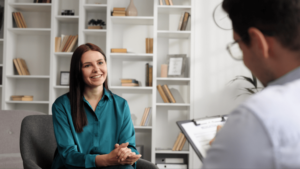 a person sitting in a chair talking to another person