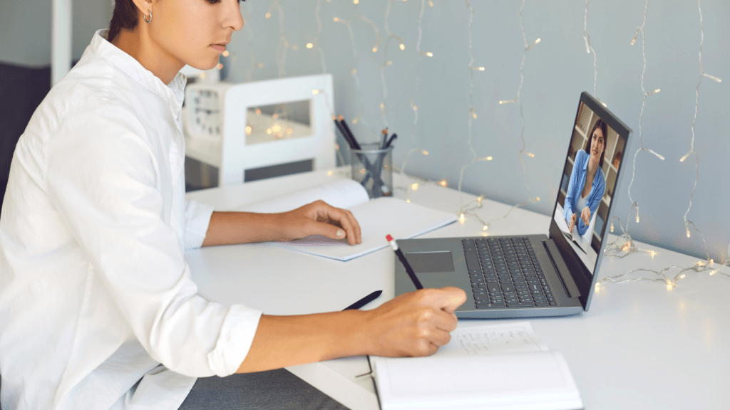 a person sitting on a couch with a laptop on their lap