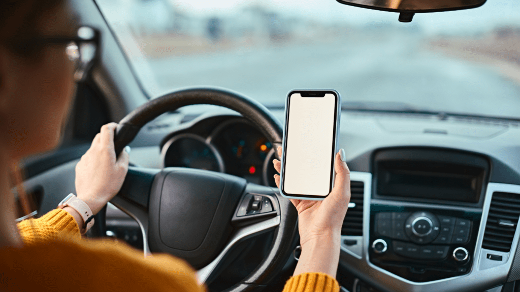 a person using their phone while driving a car