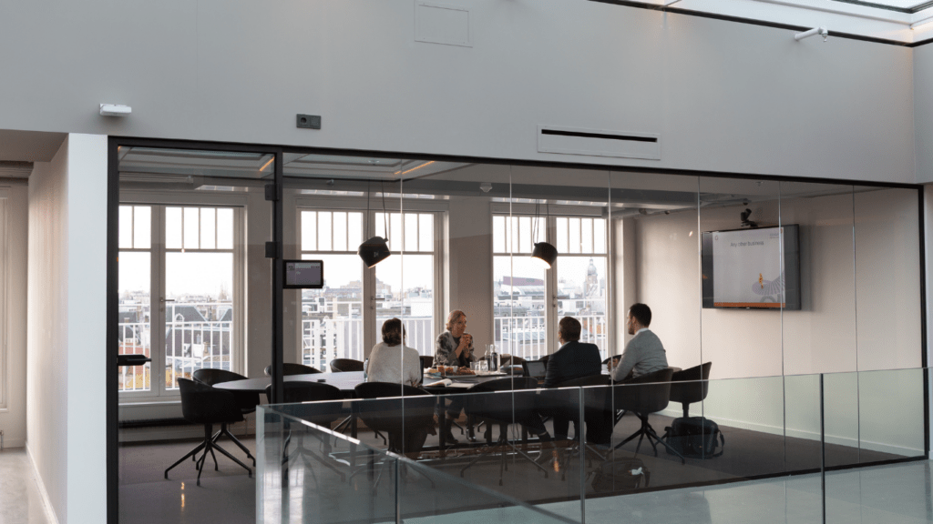 an office with a desk, chairs and a computer