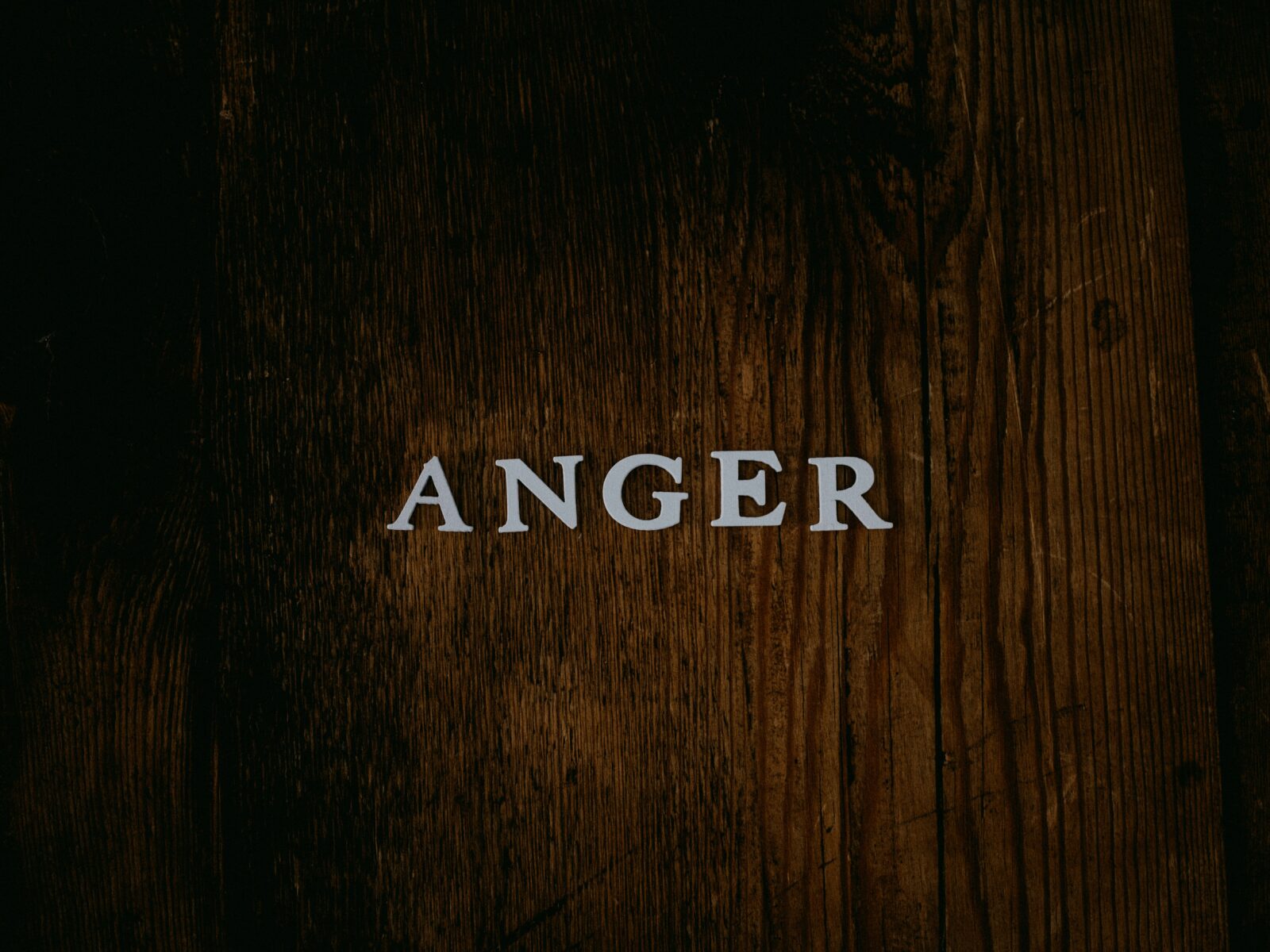 The word ANGER on a black background.
