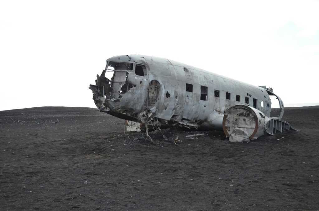 A crashed aircraft wreckage in a deserted landscape, evoking mystery and history.
